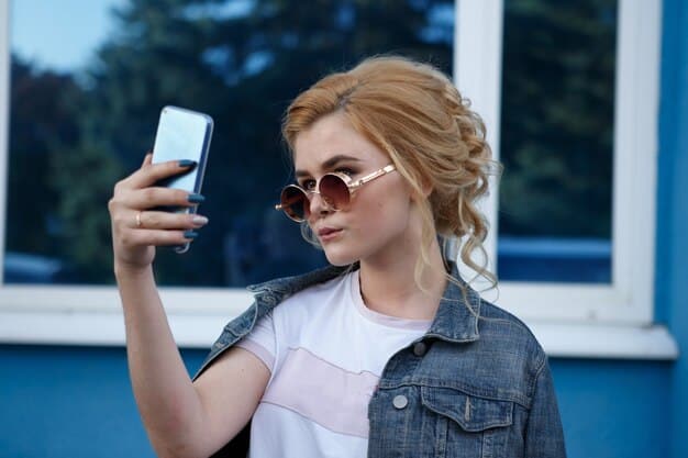 A woman using her smartphone to virtually try on sunglasses. The smartphone screen shows her face with the sunglasses superimposed on it, creating a realistic and engaging experience. The background is a well-lit and modern retail store.