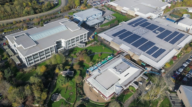 A photograph of a solar-powered warehouse with electric delivery vehicles, symbolizing the shift towards sustainability in the US retail supply chain. Include images of ethically sourced products and fair trade certifications on packaging.